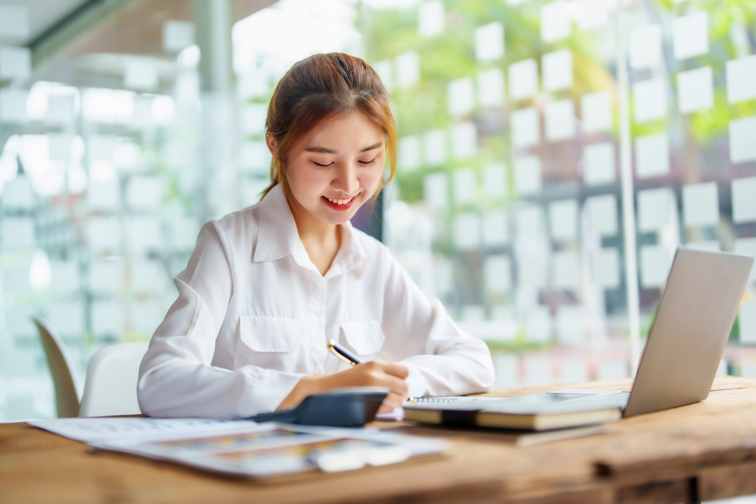 smiling businesswoman working office scaled